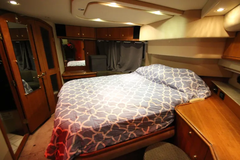 Slide: The Image of Luxurious bedroom interior of 2003 Cruisers Yachts 4450 Express Motoryacht with elegant wood finishes. - 66