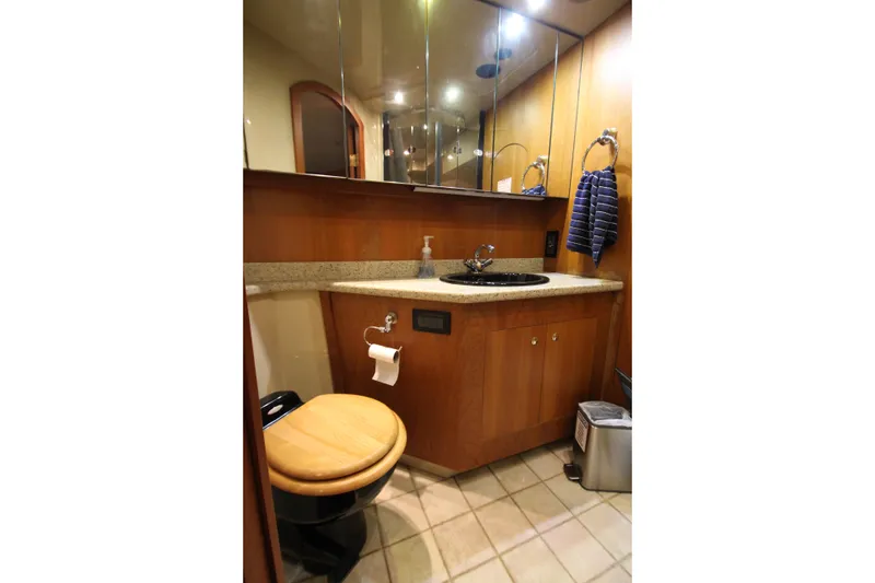 Slide: The Image of Luxurious bathroom in 2003 Cruisers Yachts 4450 Express Motoryacht with wood accents and modern fixtures. - 67
