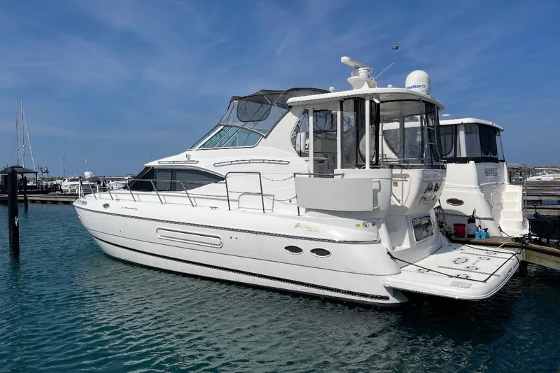 The Image of 2003 Cruisers Yachts 4450 Express Motoryacht docked in harbor. - 0