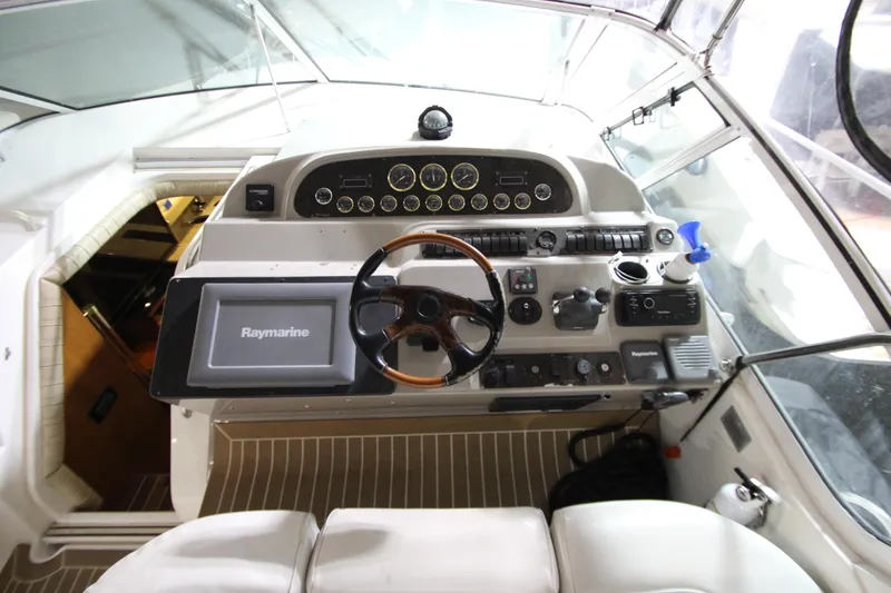 Slide: The Image of 2003 Cruisers Yachts 4450 Express Motoryacht helm with Raymarine navigation system. - 17