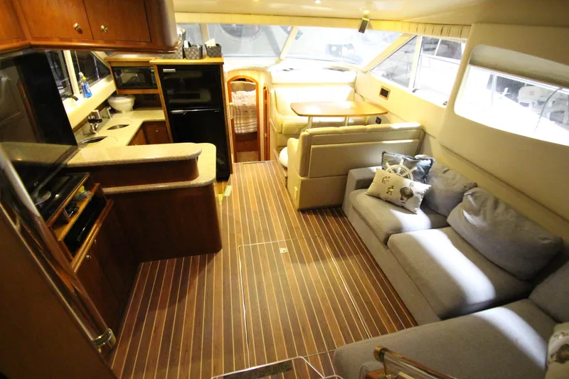 Slide: The Image of Luxurious interior of 2003 Cruisers Yachts 4450 Express Motoryacht with modern kitchen and seating area. - 26