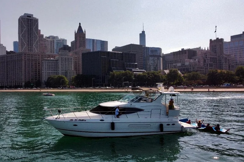 Slide: The Image of 2003 Cruisers Yachts 4450 Express Motoryacht in front of city skyline. - 3