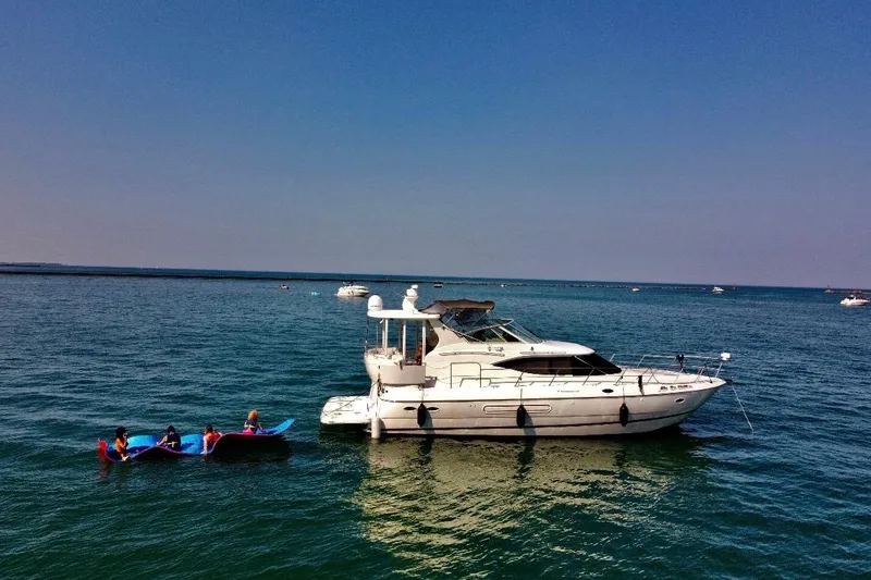 Slide: The Image of 2003 Cruisers Yachts 4450 Express Motoryacht on open sea. - 4