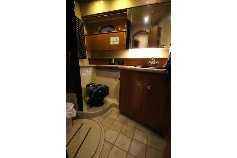 Slide: The Image of Luxurious bathroom in 2003 Cruisers Yachts 4450 Express Motoryacht with wood cabinetry and modern fixtures. - 51