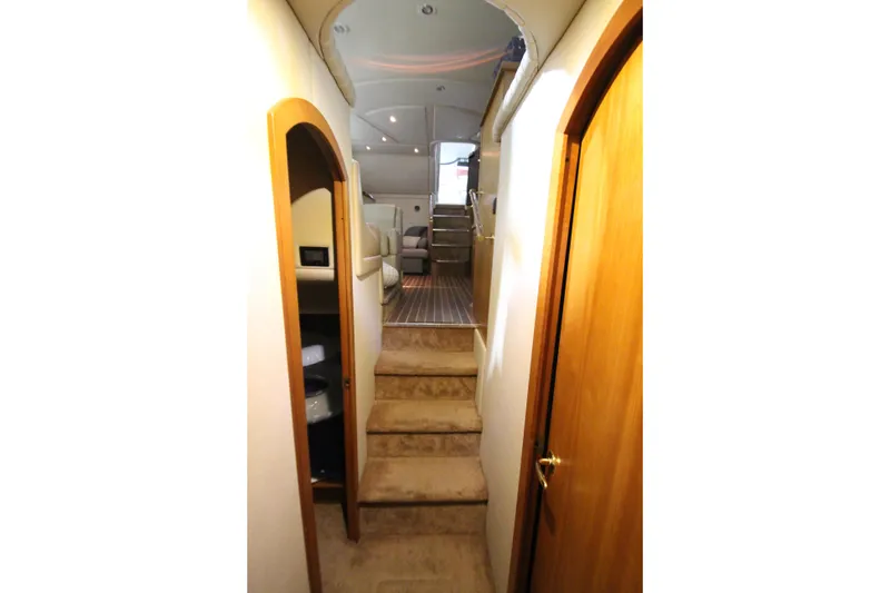 Slide: The Image of Interior view of 2003 Cruisers Yachts 4450 Express Motoryacht, featuring carpeted stairs and wooden doors. - 55
