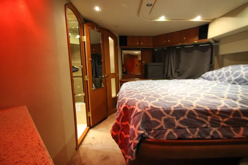 Slide: The Image of Luxurious bedroom interior of 2003 Cruisers Yachts 4450 Express Motoryacht with elegant wood finishes. - 59