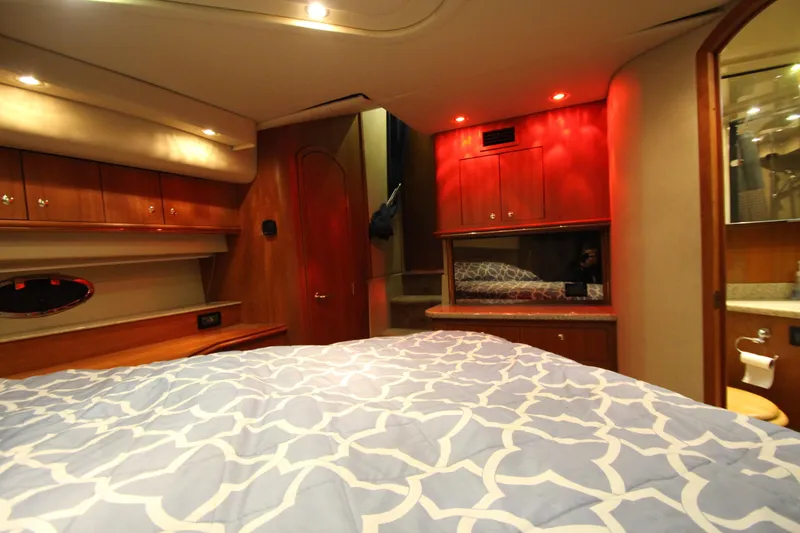 Slide: The Image of Luxurious 2003 Cruisers Yachts 4450 Express Motoryacht bedroom interior with elegant wood finishes. - 63