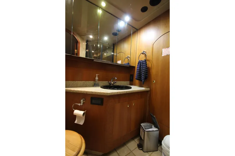 Slide: The Image of Luxurious bathroom in 2003 Cruisers Yachts 4450 Express Motoryacht with wood cabinetry. - 68