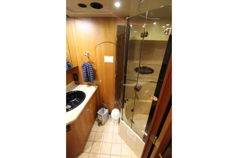 Slide: The Image of Luxurious bathroom in 2003 Cruisers Yachts 4450 Express Motoryacht with glass shower. - 72