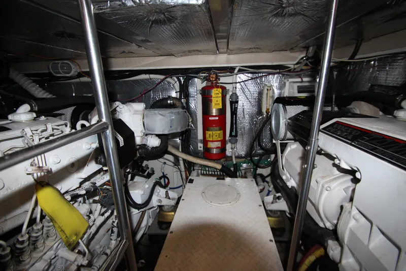 Slide: The Image of Engine room of 2003 Cruisers Yachts 4450 Express Motoryacht with visible fire extinguisher. - 73