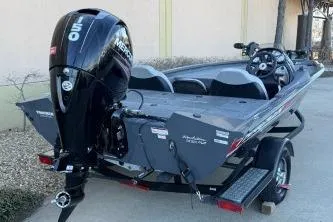 Slide: The Image of 2018 Tracker Pro Team 195 TXW boat with outboard motor, parked on a trailer. - 4