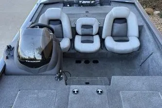 Slide: The Image of 2018 Tracker Pro Team 195 TXW boat interior with gray seating and steering console. - 5