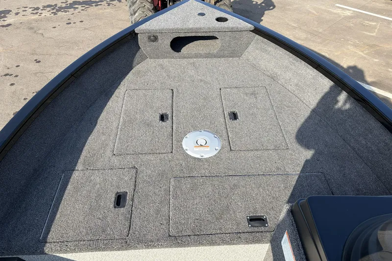 Slide: The Image of 2026 Crestliner 1850 Kodiak SC boat deck with storage compartments and carpeted surface. - 15