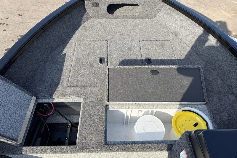 Slide: The Image of 2026 Crestliner 1850 Kodiak SC boat interior with storage compartments and equipment. - 16