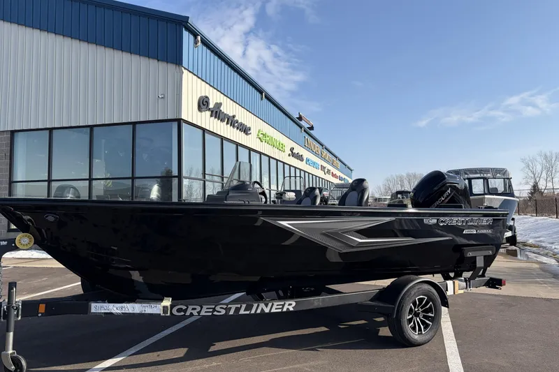 Slide: The Image of 2026 Crestliner 1850 Kodiak SC boat on trailer outside dealership. - 2
