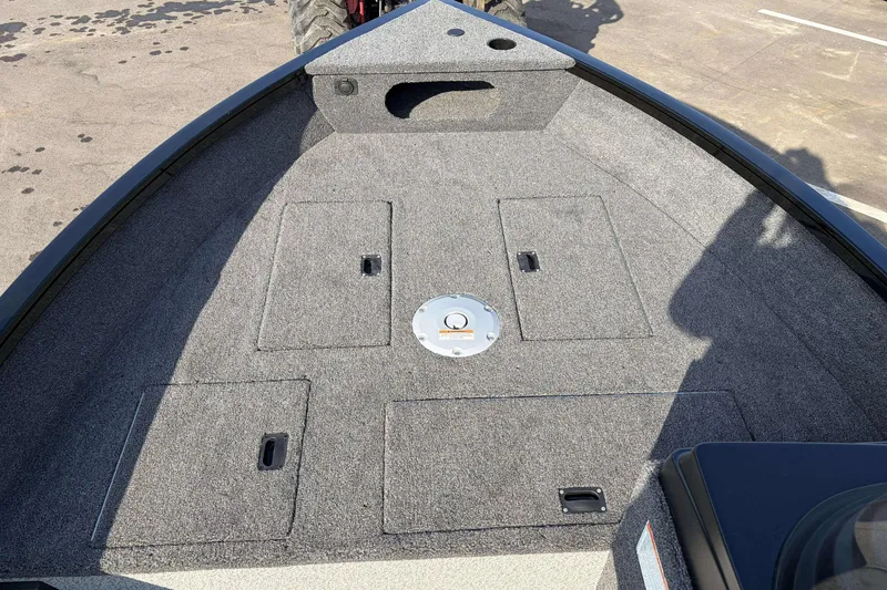 Slide: The Image of 2026 Crestliner 1850 Kodiak SC boat deck with storage compartments and carpeted surface. - 20