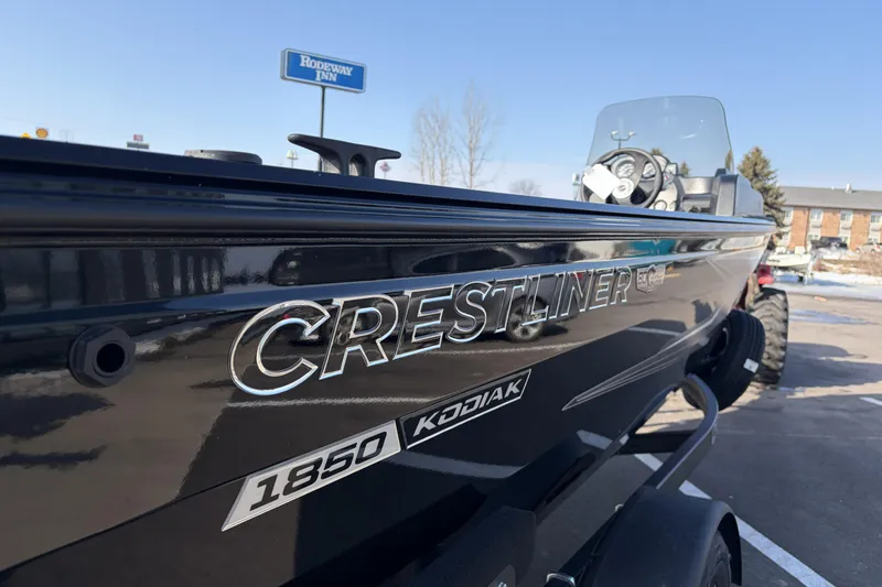 Slide: The Image of 2026 Crestliner 1850 Kodiak SC boat parked near Rodeway Inn, showcasing sleek design. - 22