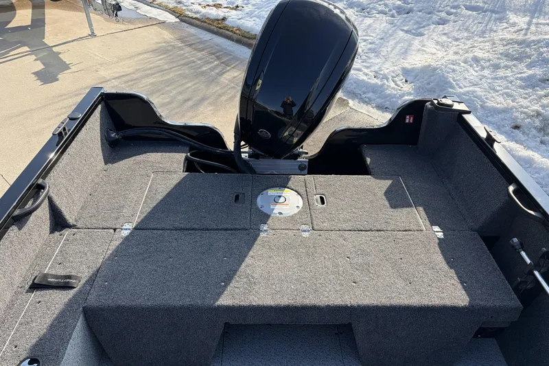 Slide: The Image of 2026 Crestliner 1850 Kodiak SC boat interior with motor, parked on snowy pavement. - 5