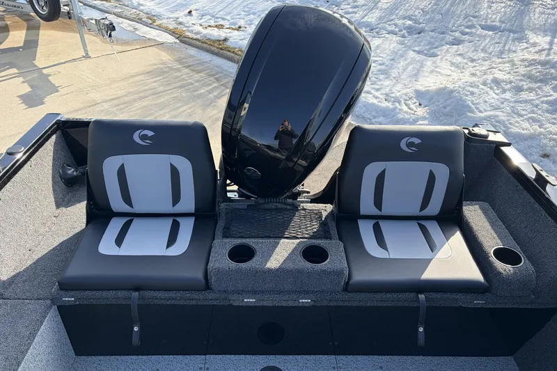 Slide: The Image of 2026 Crestliner 1850 Kodiak SC boat seats with motor, parked on snowy pavement. - 6