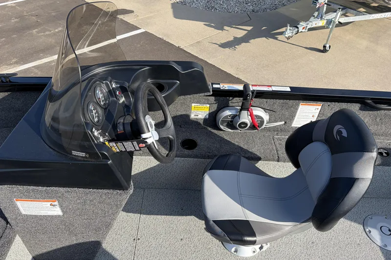 Slide: The Image of 2026 Crestliner 1850 Kodiak SC boat cockpit with steering wheel and seat. - 9