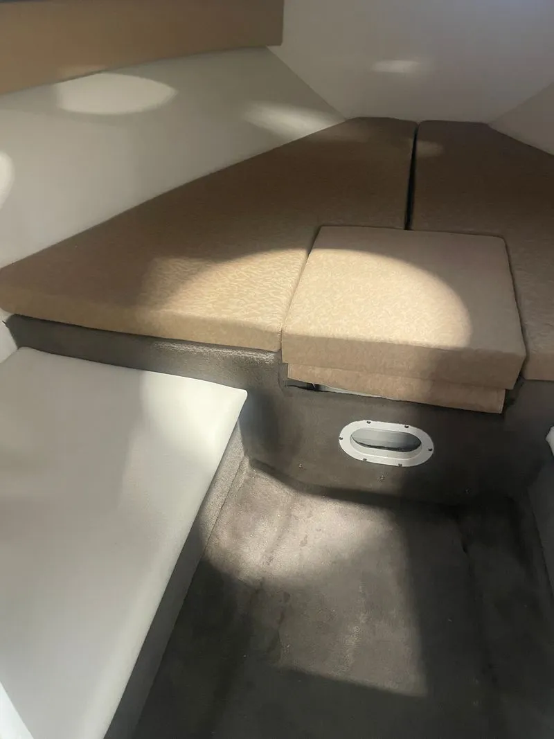 Slide: The Image of Interior of a 2001 Cobalt 227 boat with cushioned seating. - 17