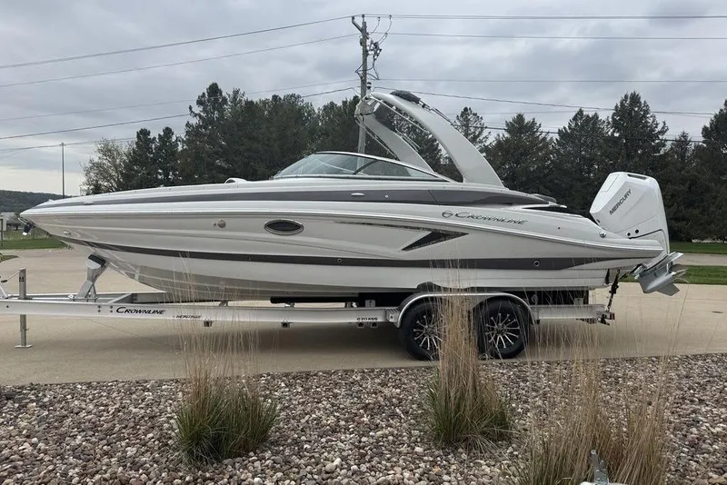 The Image of 2025 Crownline 270 XSS boat on trailer, parked outdoors, showcasing sleek design and modern features. - 1