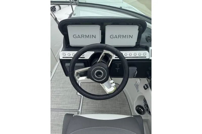 Slide: The Image of Steering wheel and Garmin displays on 2025 Crownline 270 XSS boat dashboard. - 6