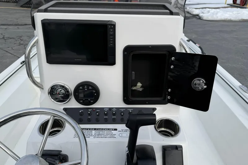 Slide: The Image of Avid 22 Recon 2026 boat dashboard with steering wheel, controls, and display screen. - 12