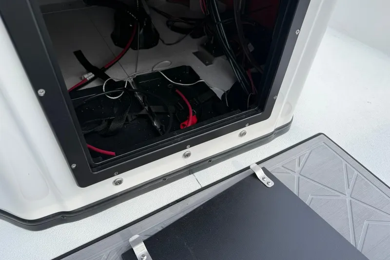 Slide: The Image of Open compartment of 2026 Avid 22 Recon boat showing wiring and storage. - 13