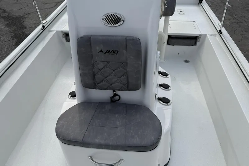 Slide: The Image of Avid 22 Recon 2026 boat interior with cushioned seating and rod holders. - 14
