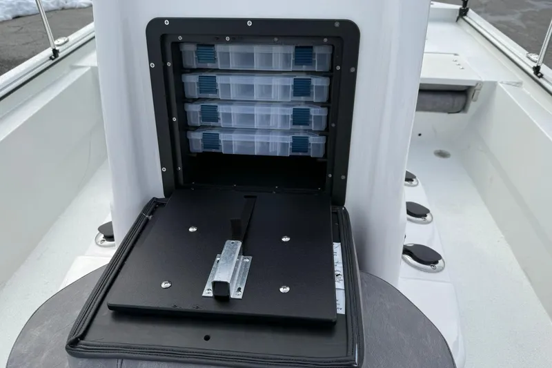 Slide: The Image of Avid 22 Recon 2026 boat with open tackle storage compartment and organized trays. - 15