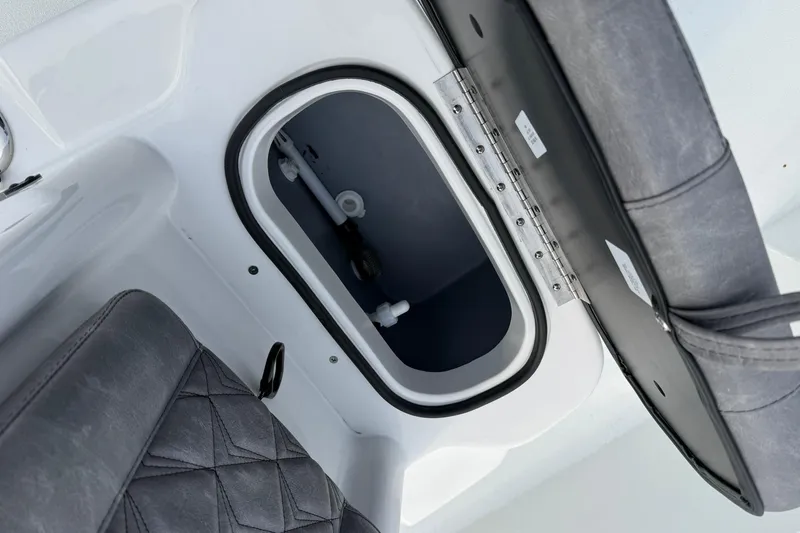 Slide: The Image of Open storage compartment in 2026 Avid 22 Recon boat with cushioned seating. - 16