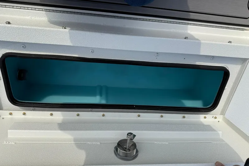 Slide: The Image of Open storage compartment on 2026 Avid 22 Recon boat, featuring a sleek design. - 19