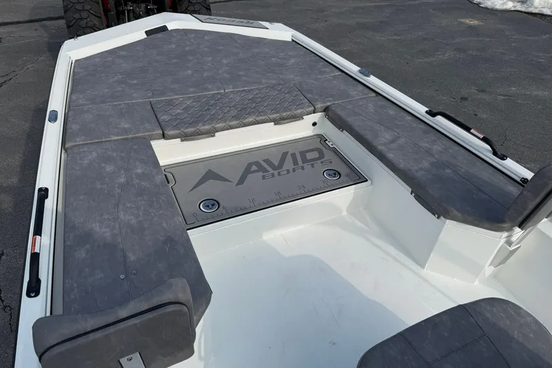 Slide: The Image of Avid 22 Recon 2026 boat interior with gray seating and branded flooring. - 21