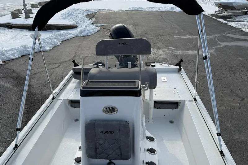Slide: The Image of Avid 22 Recon 2026 boat with console and seating, parked on snowy pavement. - 25