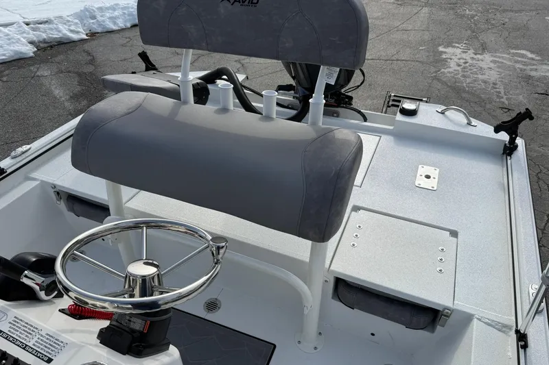 Slide: The Image of Avid 22 Recon 2026 boat interior with steering wheel and seating on snowy pavement. - 26