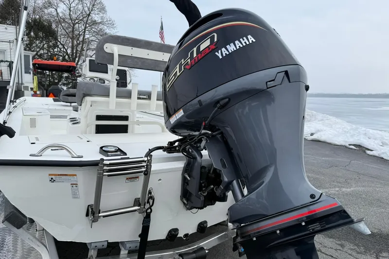 Slide: The Image of Avid 22 Recon 2026 boat with Yamaha outboard motor by a snowy lakeside. - 4