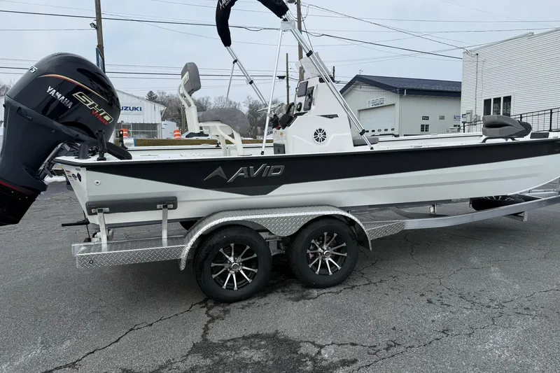 Slide: The Image of 2026 Avid 22 Recon boat on trailer with Yamaha engine, parked outdoors. - 6