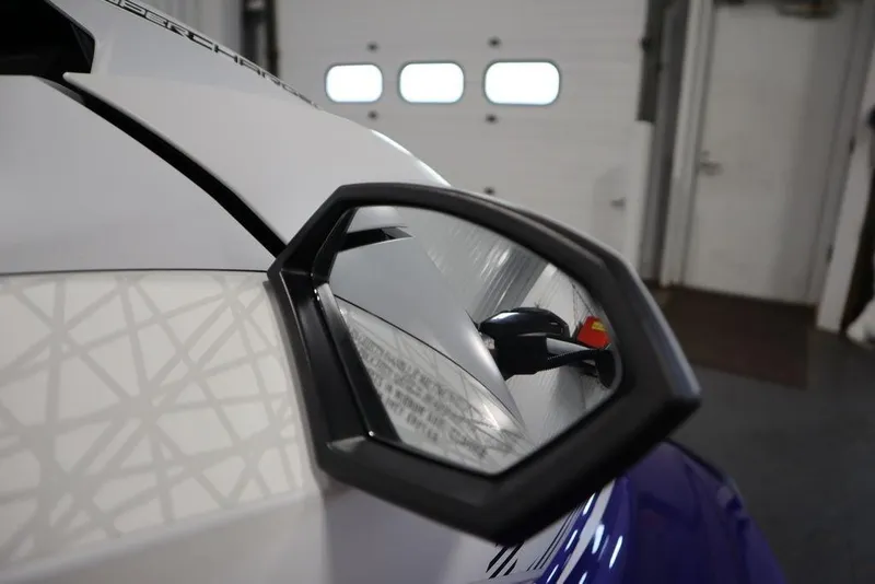 Slide: The Image of 2024 Yamaha WaveRunner GP SVHO side mirror detail in a garage setting. - 10