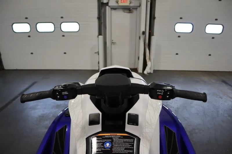 Slide: The Image of 2024 Yamaha WaveRunner GP SVHO handlebars in a garage setting. - 11