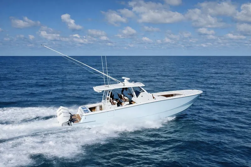 The Image of 2022 Barker Boatworks 40 HPC cruising on open ocean under blue sky. - 1