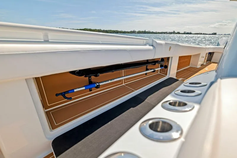Slide: The Image of 2022 Barker Boatworks 40 HPC deck with rod holders and storage, on a sunny day. - 20