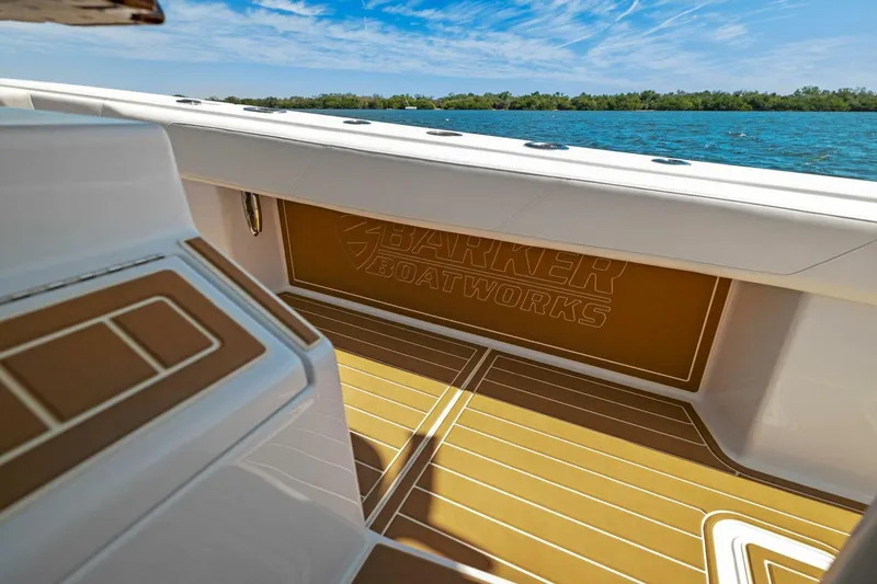 Slide: The Image of 2022 Barker Boatworks 40 HPC interior with custom flooring, overlooking serene water and blue sky. - 21