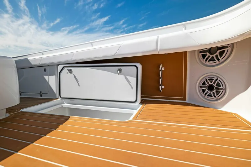 Slide: The Image of 2022 Barker Boatworks 40 HPC deck with storage and speakers under a clear blue sky. - 17