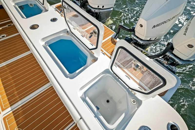 Slide: The Image of 2022 Barker Boatworks 40 HPC with open storage compartments and Mercury outboard engines. - 31