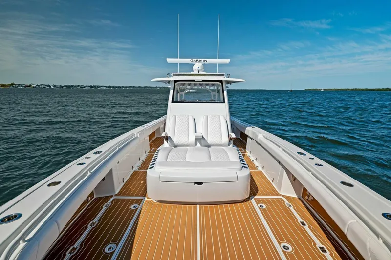 Slide: The Image of 2022 Barker Boatworks 40 HPC on water, featuring sleek design and spacious deck. - 4