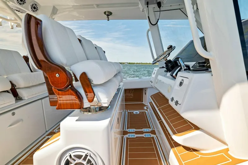 Slide: The Image of 2022 Barker Boatworks 40 HPC interior with luxurious seating and modern helm, overlooking the water. - 7