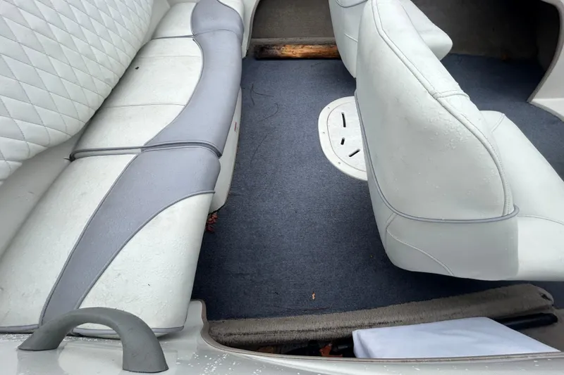 Slide: The Image of 2006 Tahoe Q4 boat interior with white and gray seating, carpeted floor. - 11