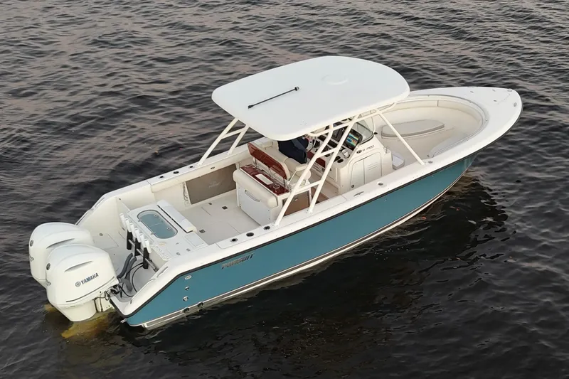 Slide: The Image of 2014 Pursuit S 280 Sport boat on water, featuring dual Yamaha engines. - 10