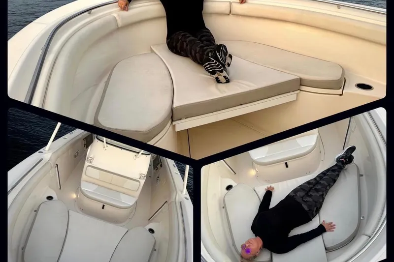 Slide: The Image of 2014 Pursuit S 280 Sport boat interior with cushioned seating and person relaxing. - 25